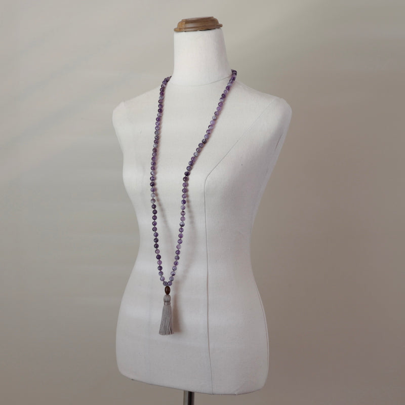 Intuition Mala Beads. Hand-knotted with beautiful, untreated, high-grade Amethyst beads, featuring a wooden guru bead and handmade cotton tassel.