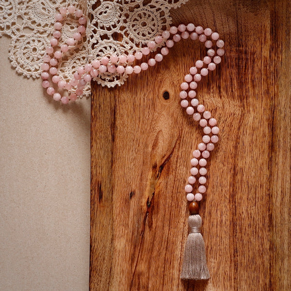 Love Mala Beads. Hand-knotted with beautiful, untreated, high-grade Rose Quartz beads, featuring a wooden guru bead and handmade cotton tassel.