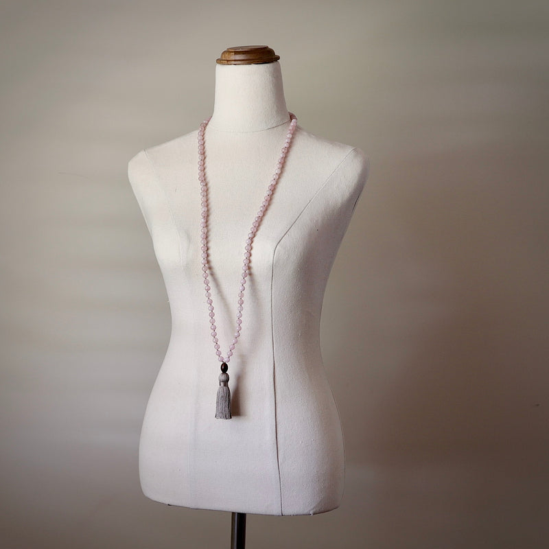 Love Mala Beads. Hand-knotted with beautiful, untreated, high-grade Rose Quartz beads, featuring a wooden guru bead and handmade cotton tassel.